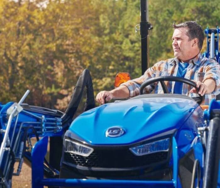 Routine Yard Maintenance with Gas-Powered Mower Person mowing green grass with a heavy-duty riding mower.